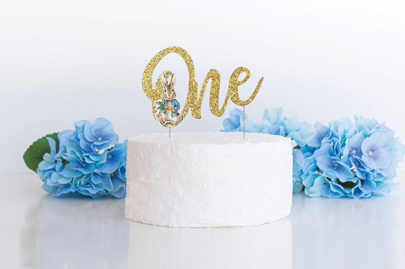 Example of use, Gold Glitter "One" Peter Rabbit Cake topper pairs beautifully with White Buttercream Icing with tonal Hydrangea Blue Decorations