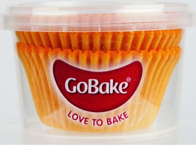 Orange standard sized cupcake papers in tub